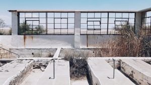 abandoned pools look through paneless windows in zzyz, california