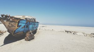 graffiti boat on sand in saltonsea