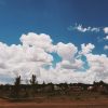 large blue and white sky over desert landscape