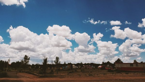 large blue and white sky over desert landscape