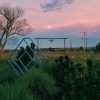 pink sunset with blue sculpture and eye