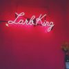 pink neon sign on pink wall that says "larb king"