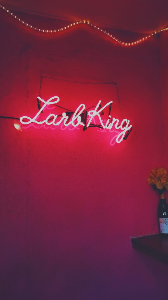 "larb king" neon sign against pink background in los angeles, california