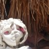 white broken doll head with pink eyes with more broken white doll heads inside