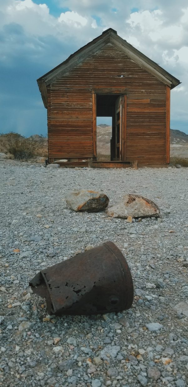 abandoned red building shot from a ground of pebbles