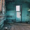 abandoned house with peeling blue paint