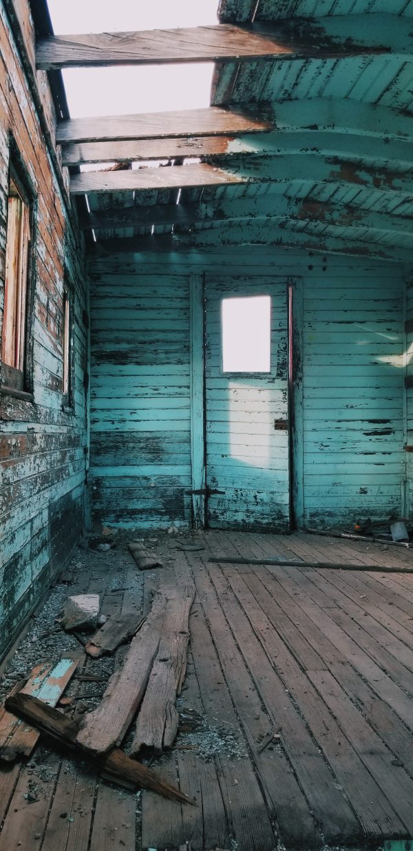 abandoned house with peeling blue paint