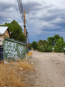 dumpster graffiti with "don't care wanna die" in marfa, texas