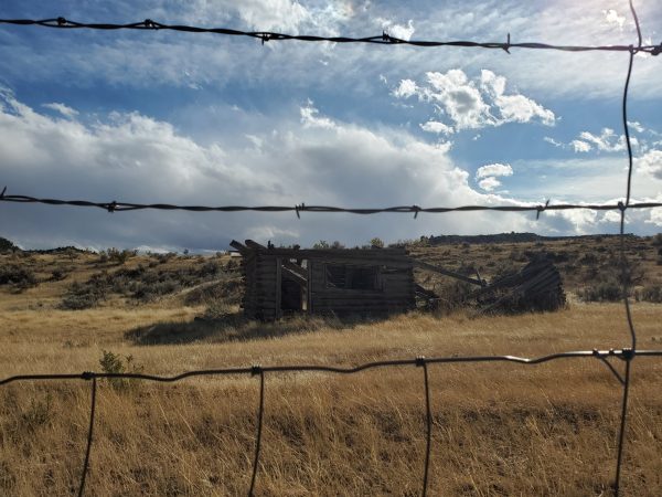 photo of abandoned building between barbwire fence