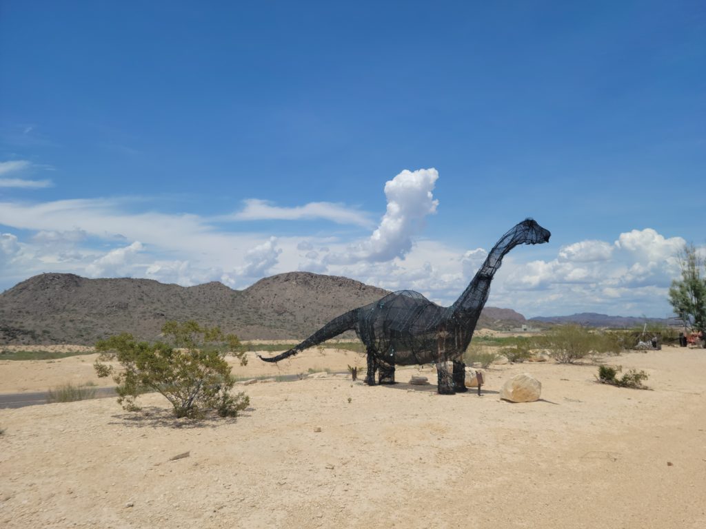 large wire dinosaur in the desert