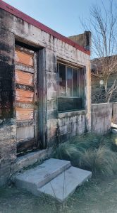 abandoned adobe with orange door in marfa, texas