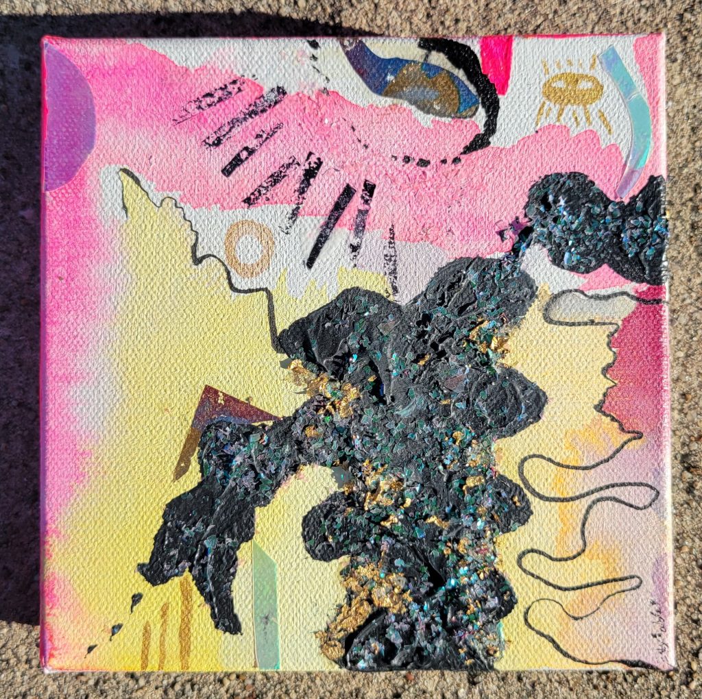 canvas art with black glittery shapes and eyes