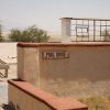 photo of abandoned pool house with "pool house" sign