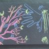 black art paper with neon lines and hands