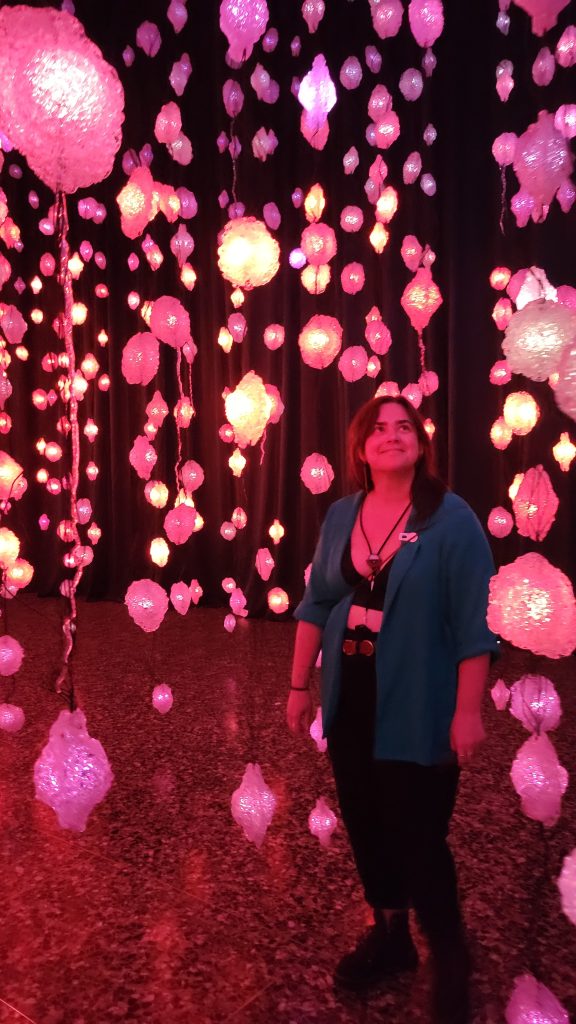 girl looks up among red art display